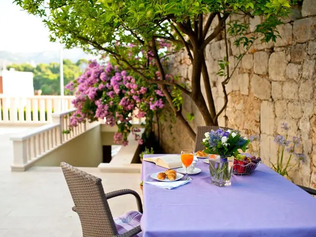 Breakfast at a garden table at California Apartments, with flowers