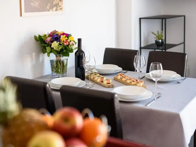 Laid table in the dining area of an apartment at California Apartments